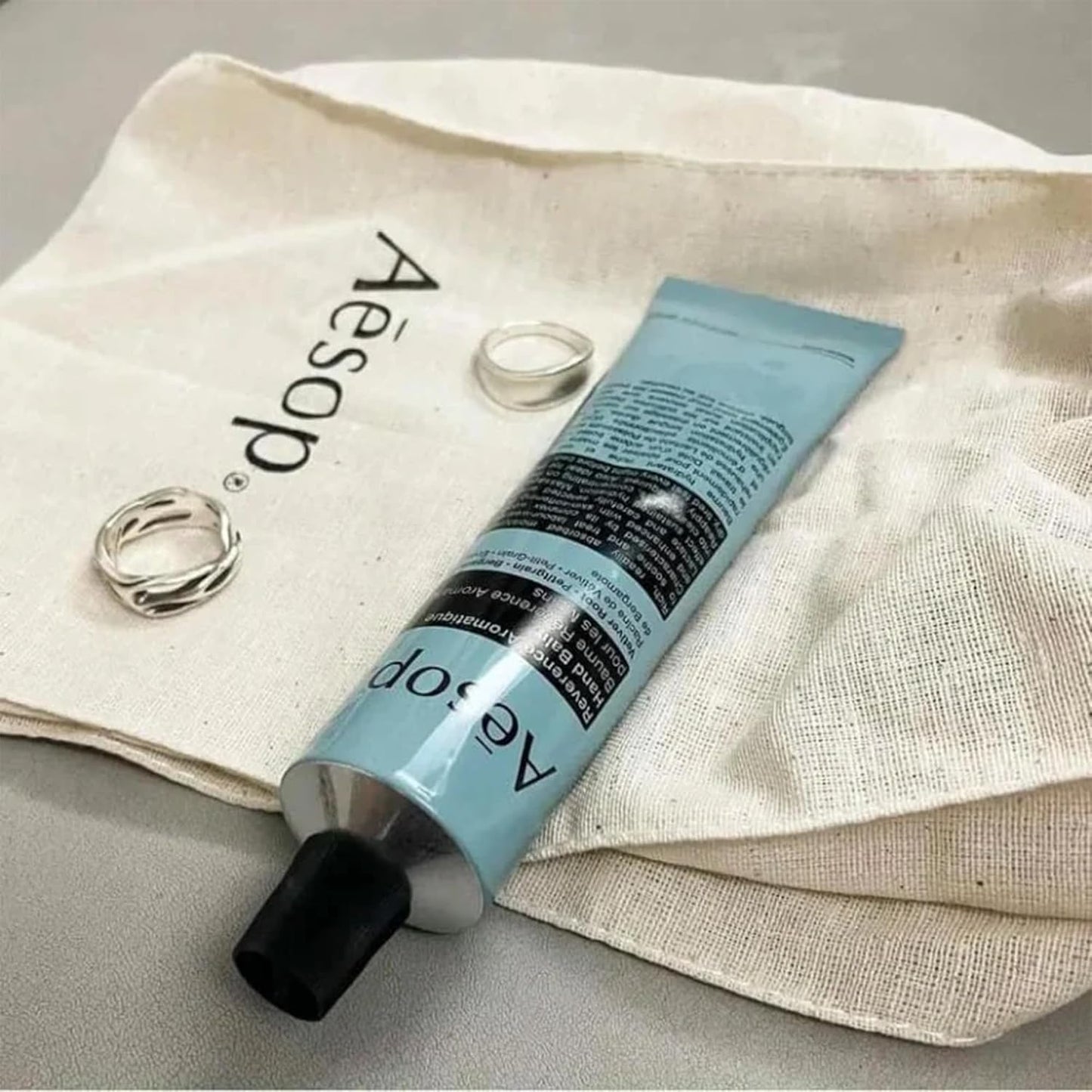 Aesop Reverence Aromatique Travel Size Hand Balm | Lotion that Gently Exfoliates Dry Hands + Nourishes with Macadamia Seed Oil and Shea Butter | 2.4 oz / 75 mL